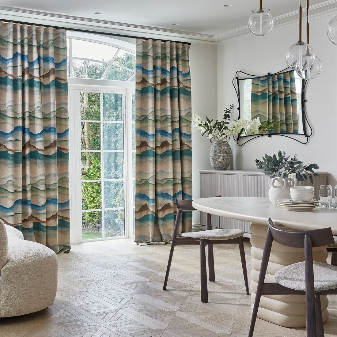 Blue green and neutral watercolour curtains in a contemporary dining room